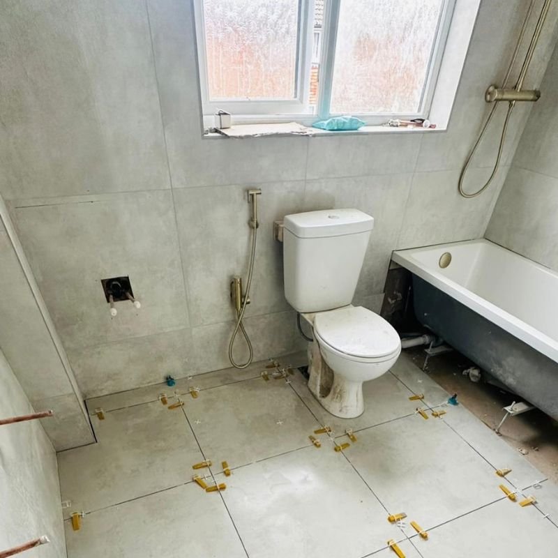 Bathroom Renovation (10) Bathroom renovation in progress, new bath fitted and floor tiles being laid