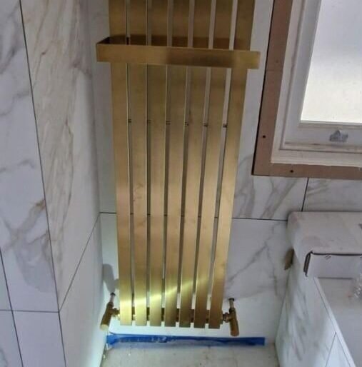 Gold designer radiator installation