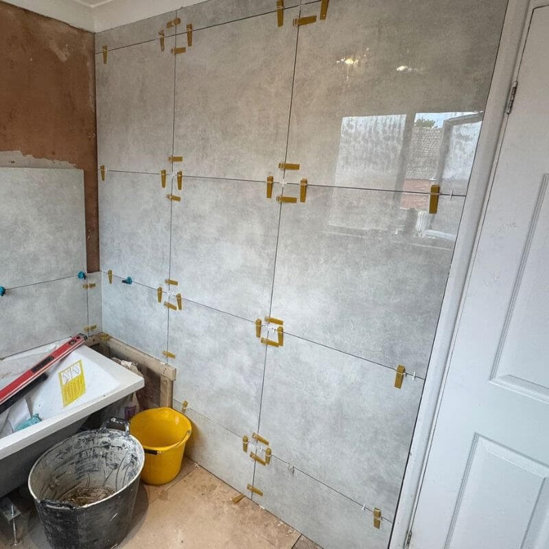 Old tiles removed and large format wall tiles going up